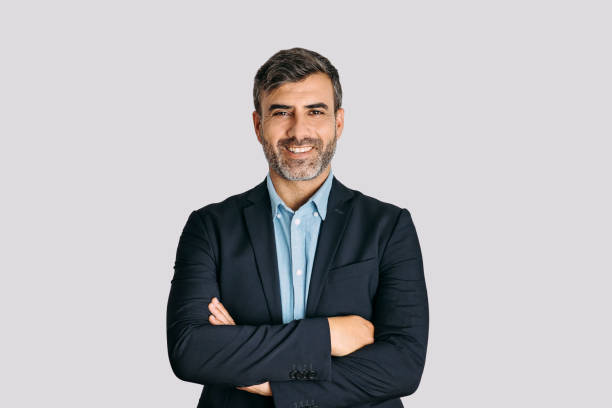 front view of businessman smiling with arms crossed on white background